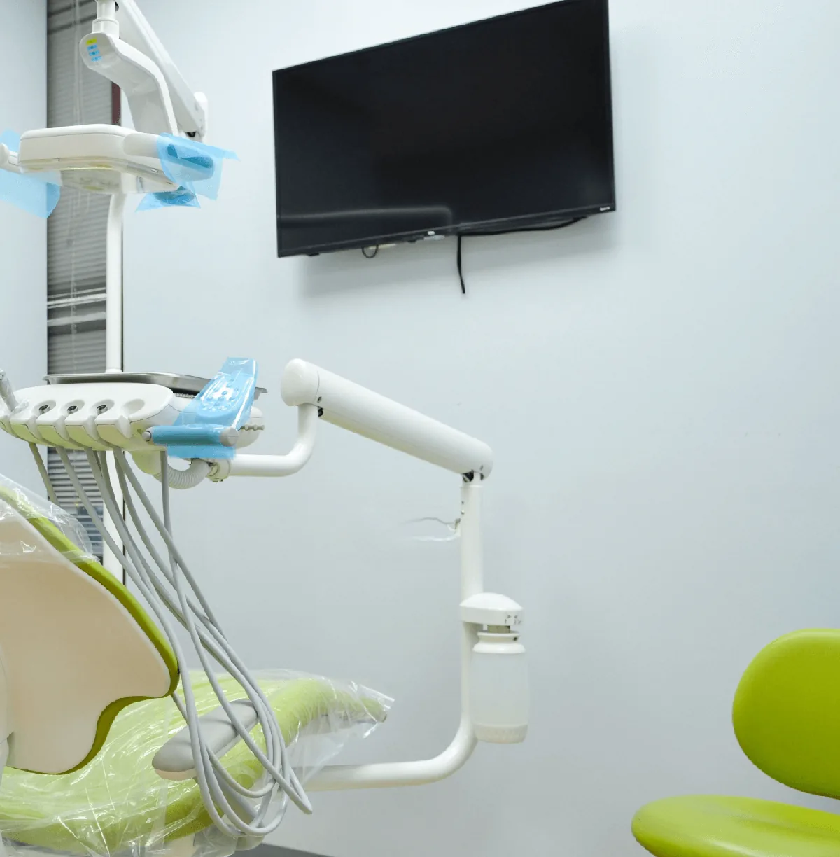 A dental chair in front of a monitor